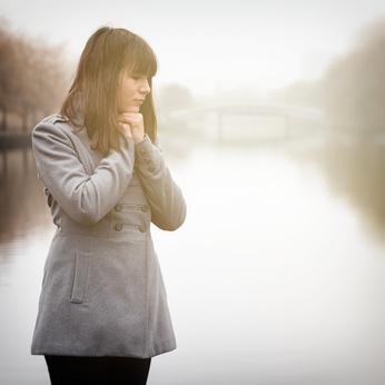 Girl praying with sombreness