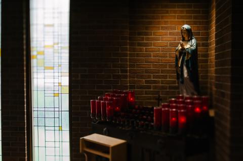 Our Lady statue with candles